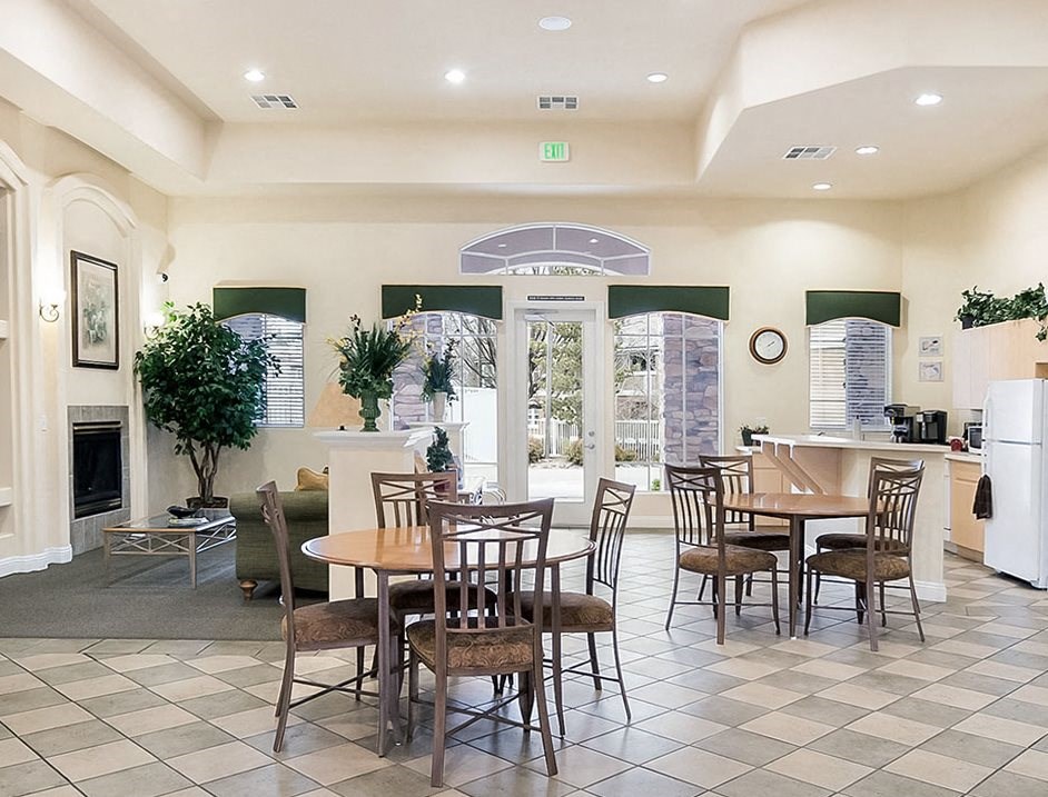 a dining room with tables and chairs and a fireplace