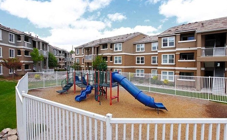 a playground in front of an apartment building
