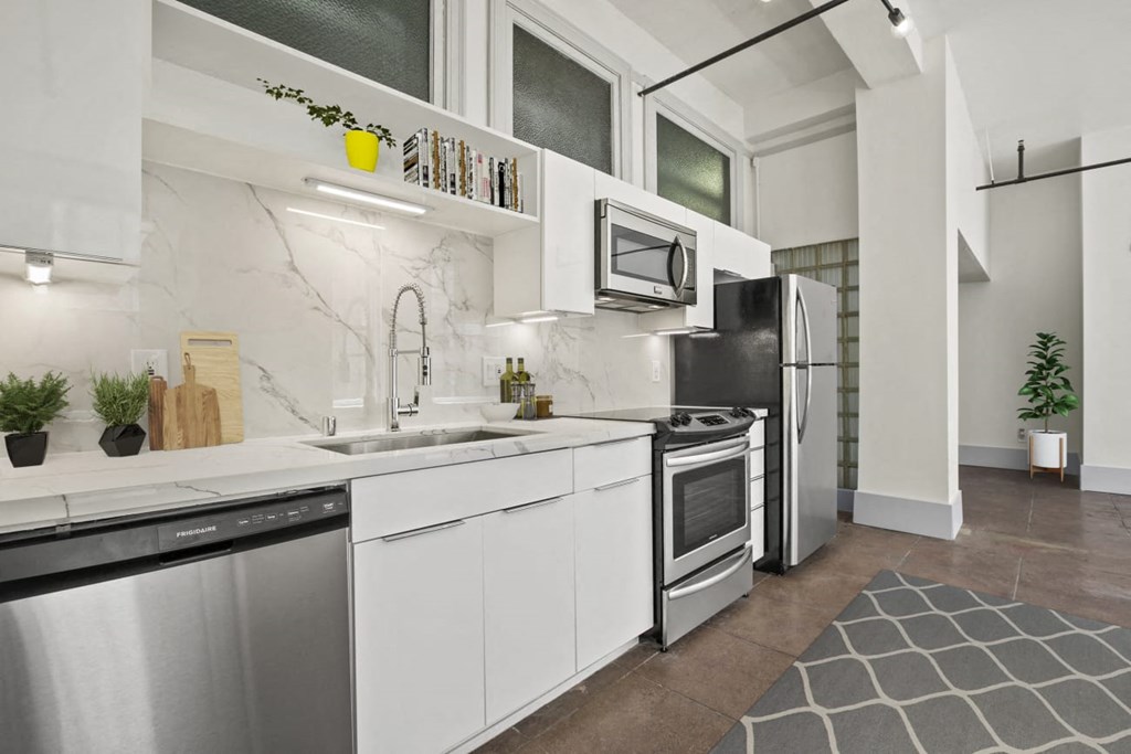a kitchen with white cabinets and stainless steel appliances