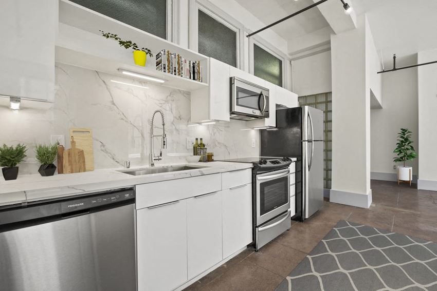 a kitchen with white cabinets and stainless steel appliances - Photo Gallery