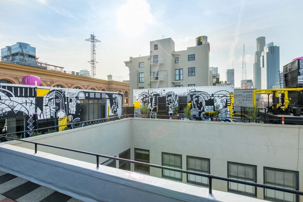 a cityscape with a mural on the side of a building