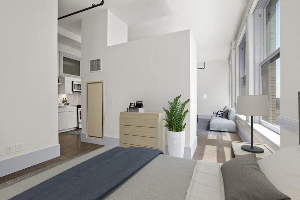 a bedroom with a large bed in front of a window