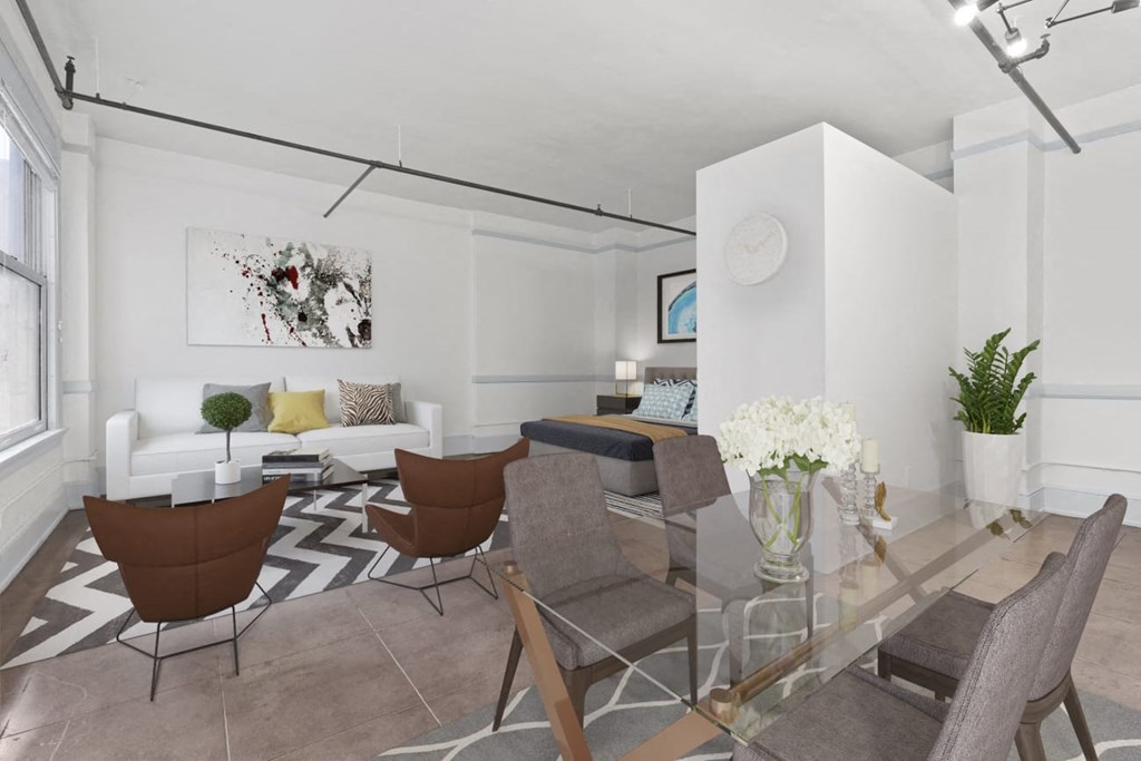 a living room with white walls and a glass table with chairs