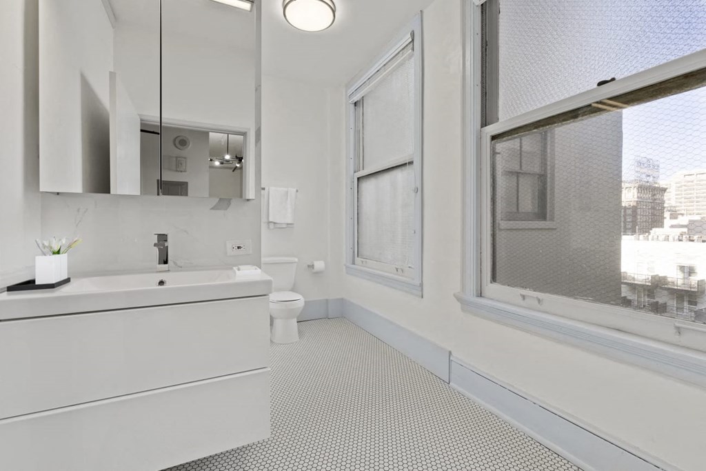 Downtown LA Apartments - Santa Fe Lofts - Spacious Bathroom with a Mirrored Vanity and Large Windows