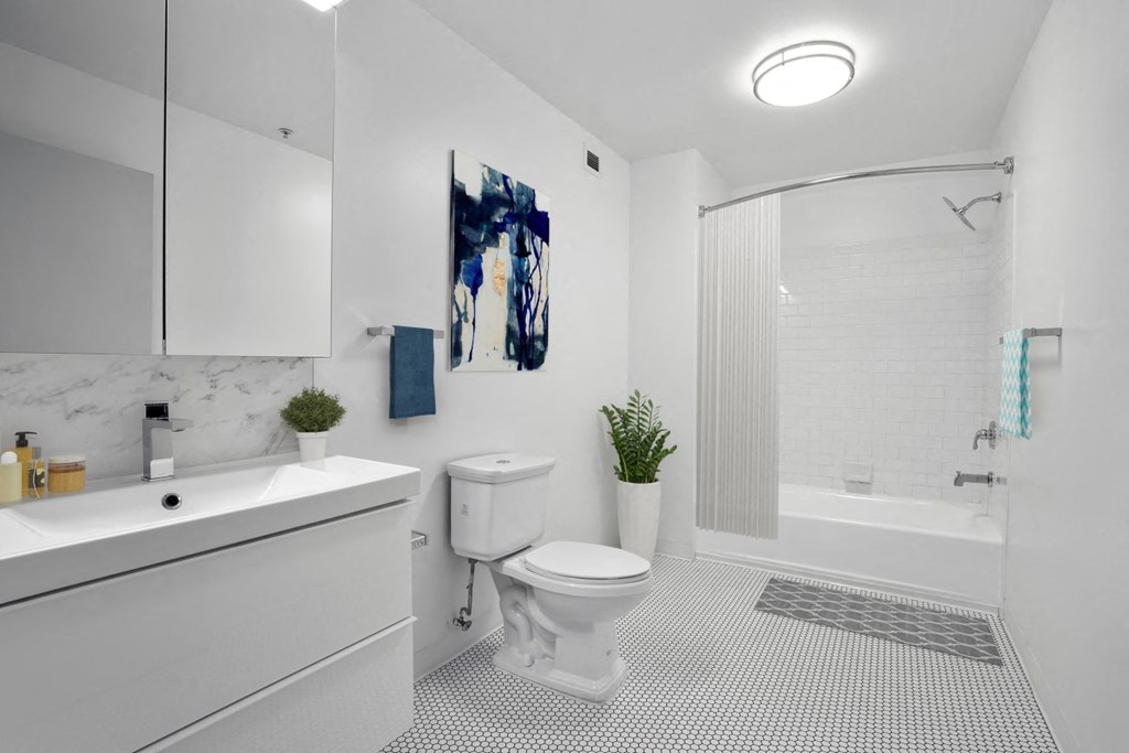 a bathroom with a white sink and toilet next to a white bathtub