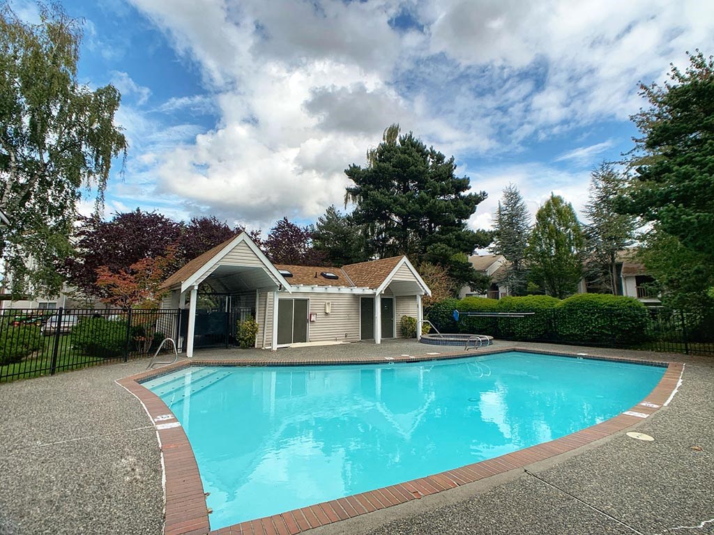 a large swimming pool in front of a house