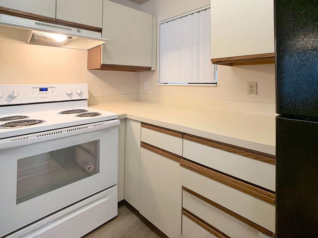a kitchen with a stove and a refrigerator