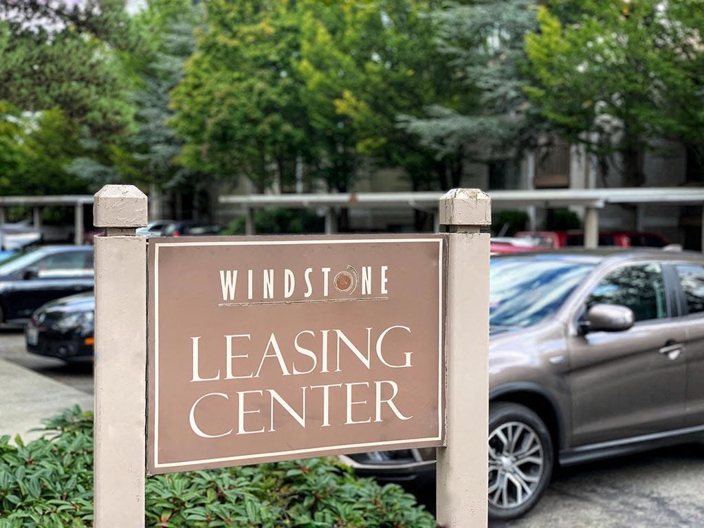 a sign that reads leasing center in front of a parking lot