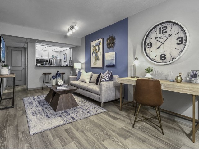 a living room with a large clock on the wall