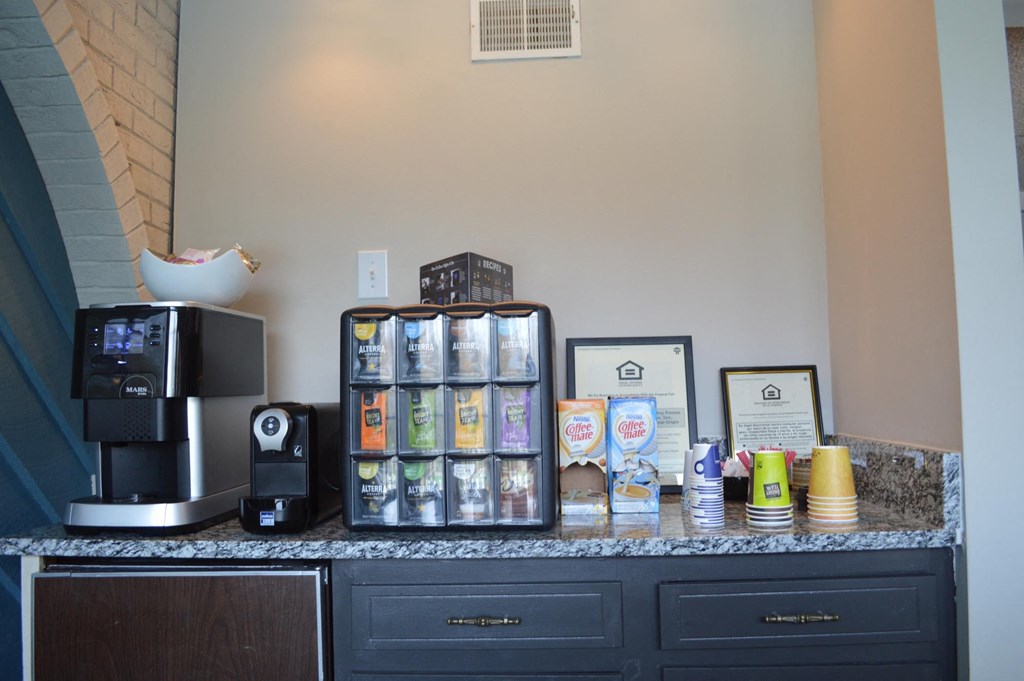 a counter with coffee and other amenities in a hotel room