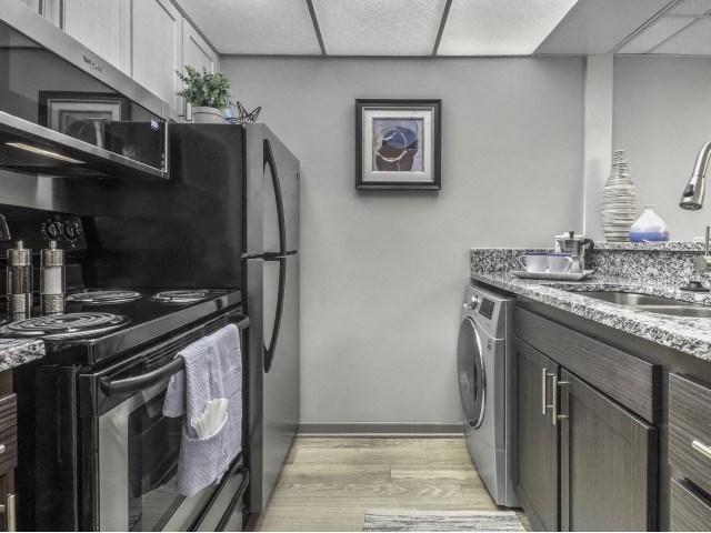 a kitchen with a stove refrigerator and dishwasher and a washing machine