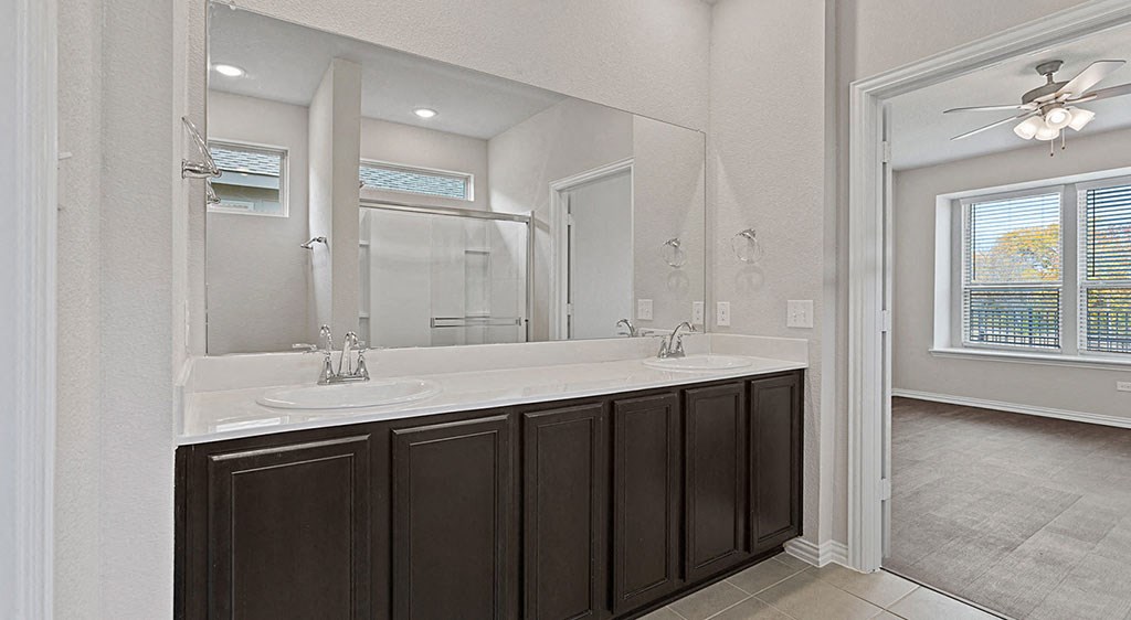 a bathroom with two sinks and a large mirror