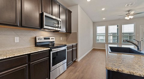 a kitchen with stainless steel appliances and granite counter tops