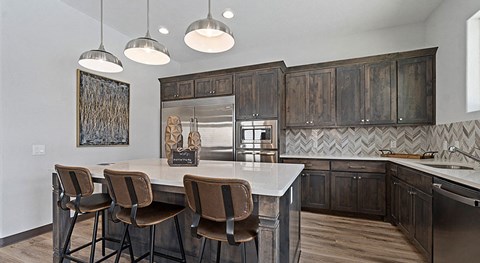 Apartments for Rent in Lewisville, TX - The Villas at Rockbrook - Kitchen with Granite Countertops, Kitchen Island, and Stainless-Steel Appliances.