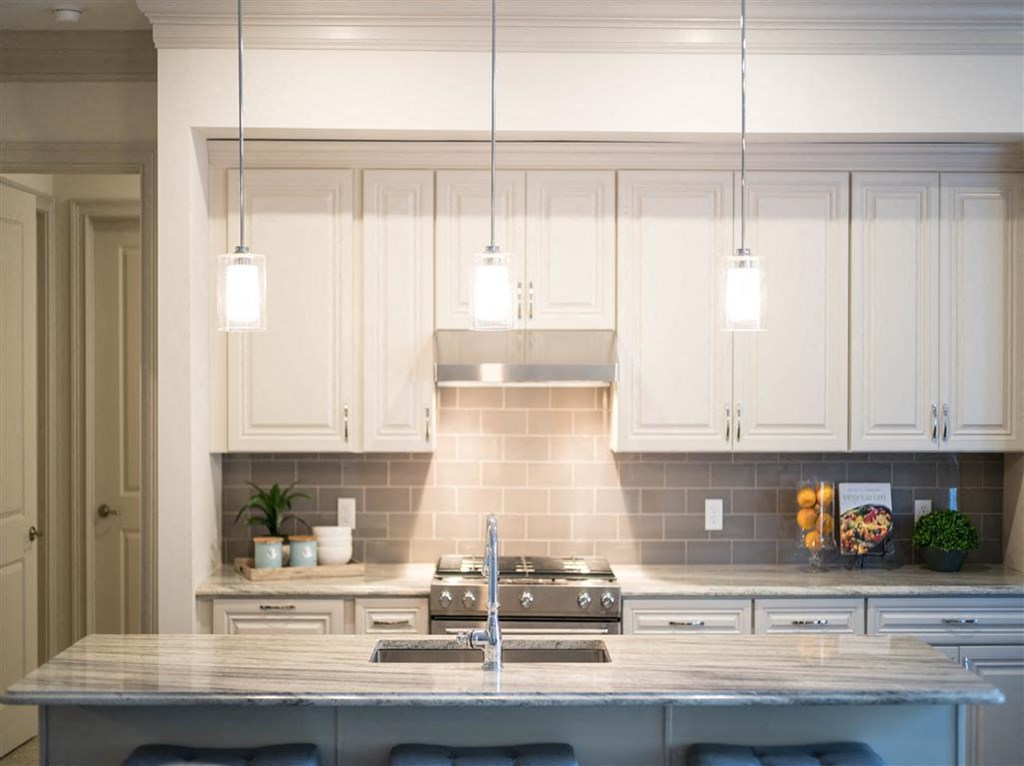 a kitchen with white cabinets and a counter top