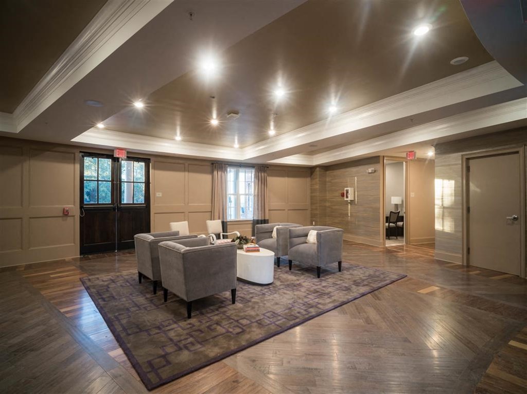 a large living room with couches and chairs