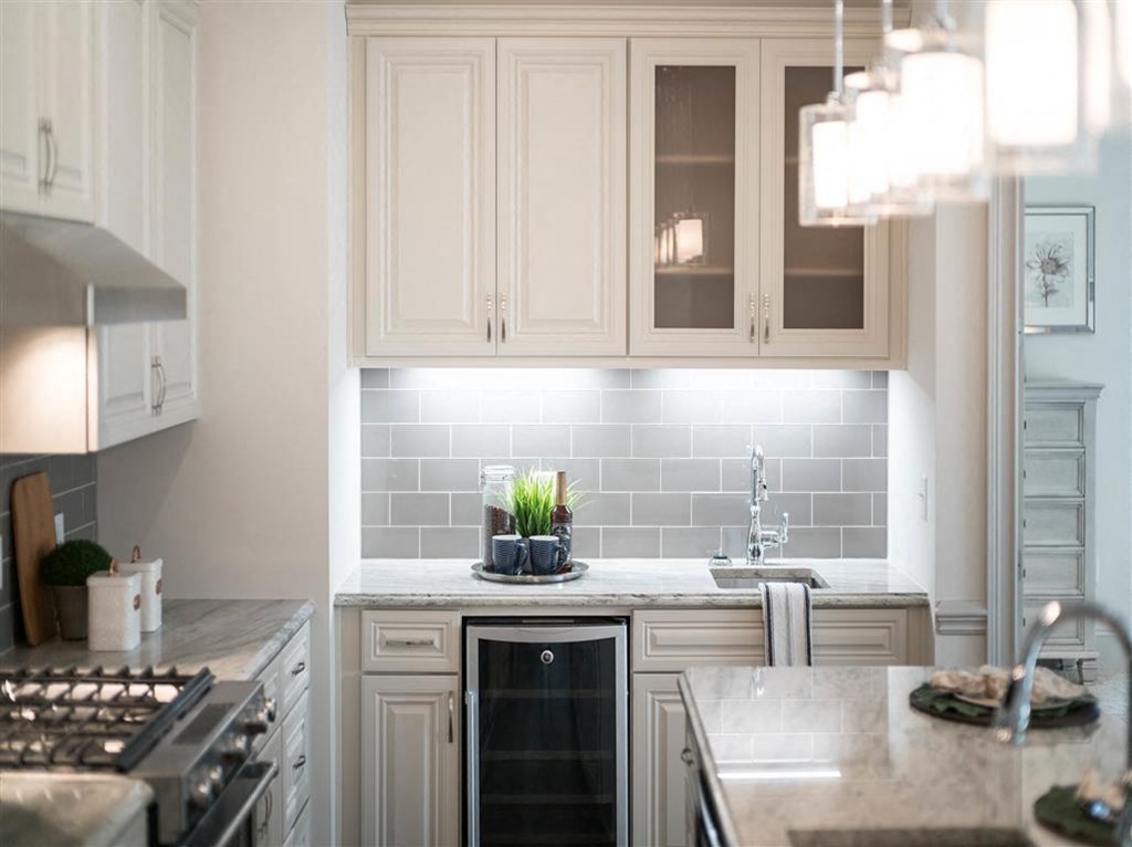 a kitchen with white cabinets and a counter top and a sink