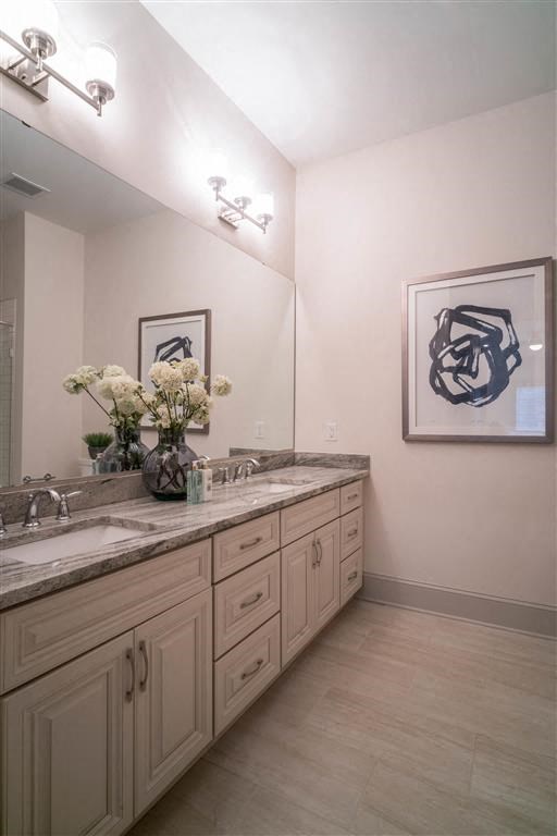 a bathroom with two sinks and a large mirror