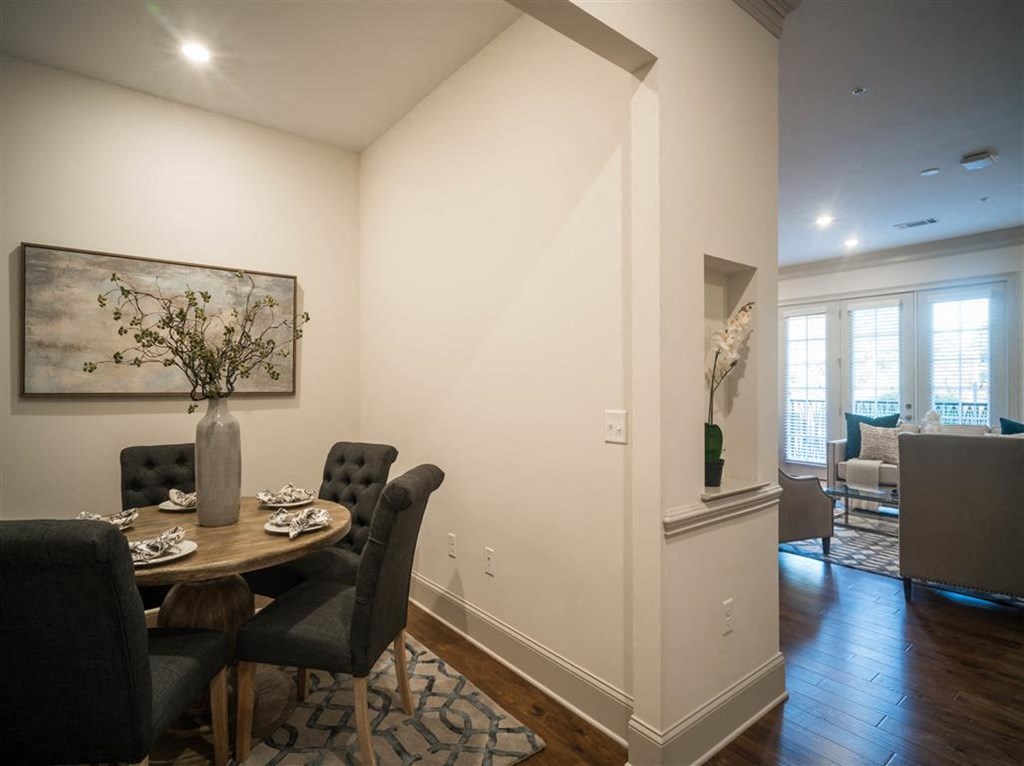 a dining room with a table and chairs