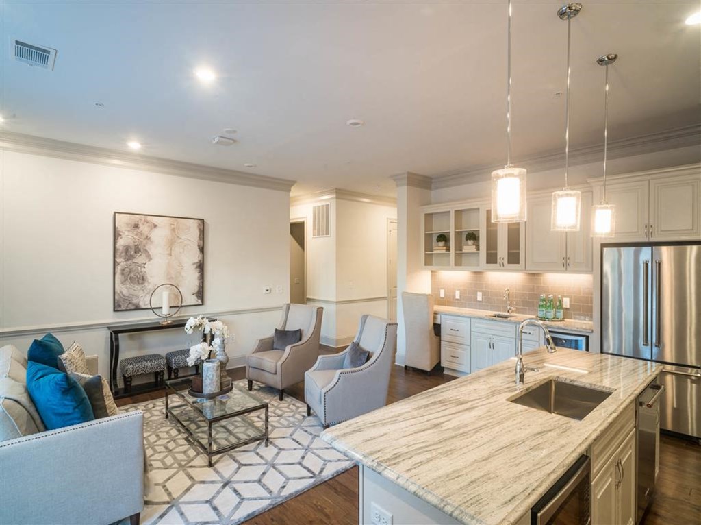 a kitchen and living room with a table and chairs