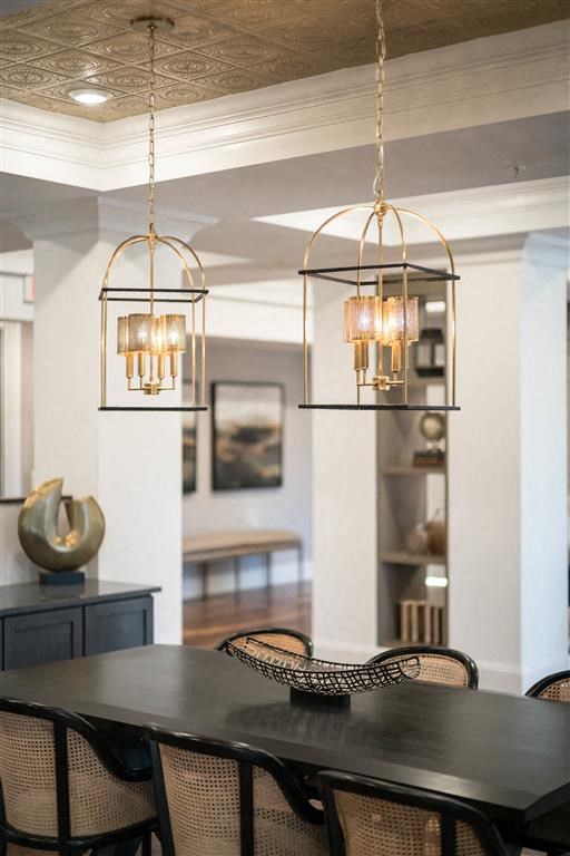 a dining room with a black table and chairs and lights