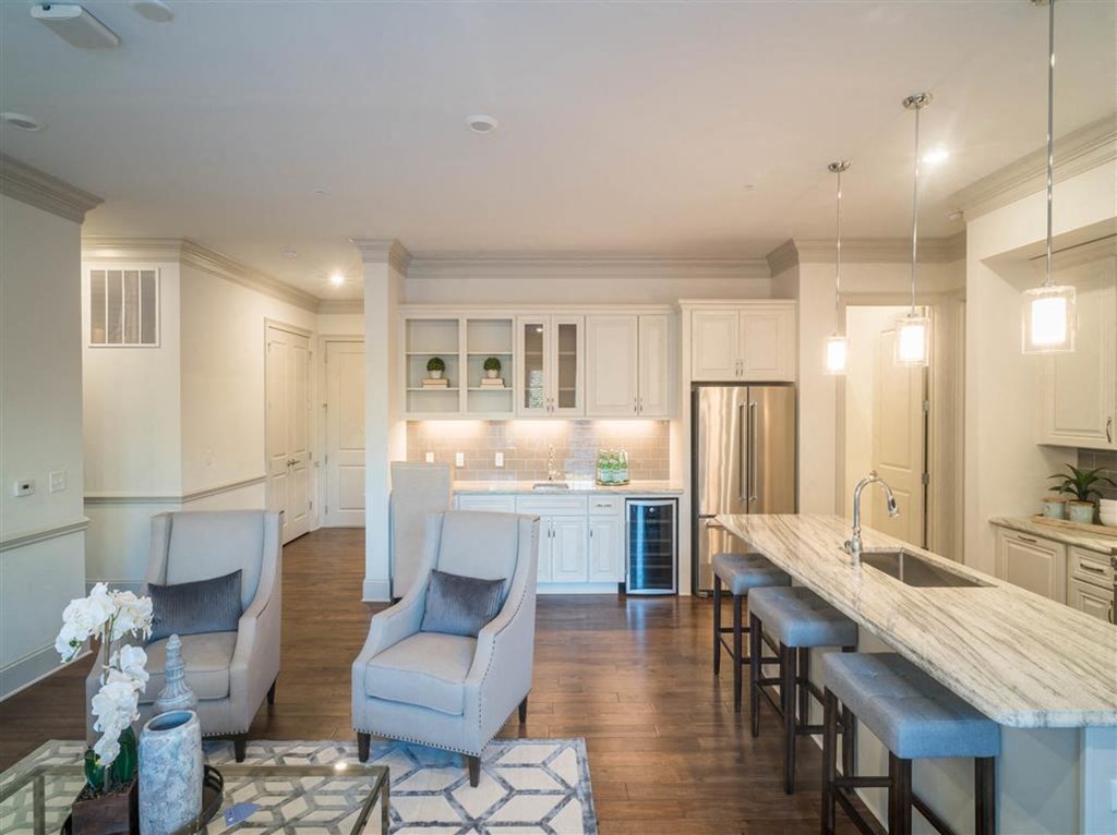 the kitchen and living room of a new home