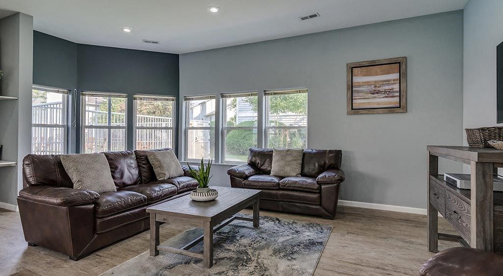 Apartments for Rent Coeur D'Alene ID - Trail Lodge - Community Lounge Area with Wood-Style Flooring and Multiple Windows