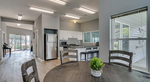 a kitchen and dining room with a table and chairs