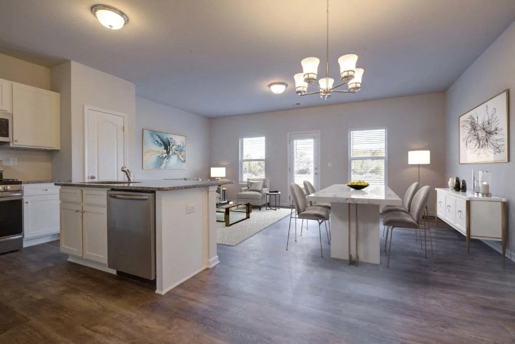a kitchen and dining room with a table and chairs
