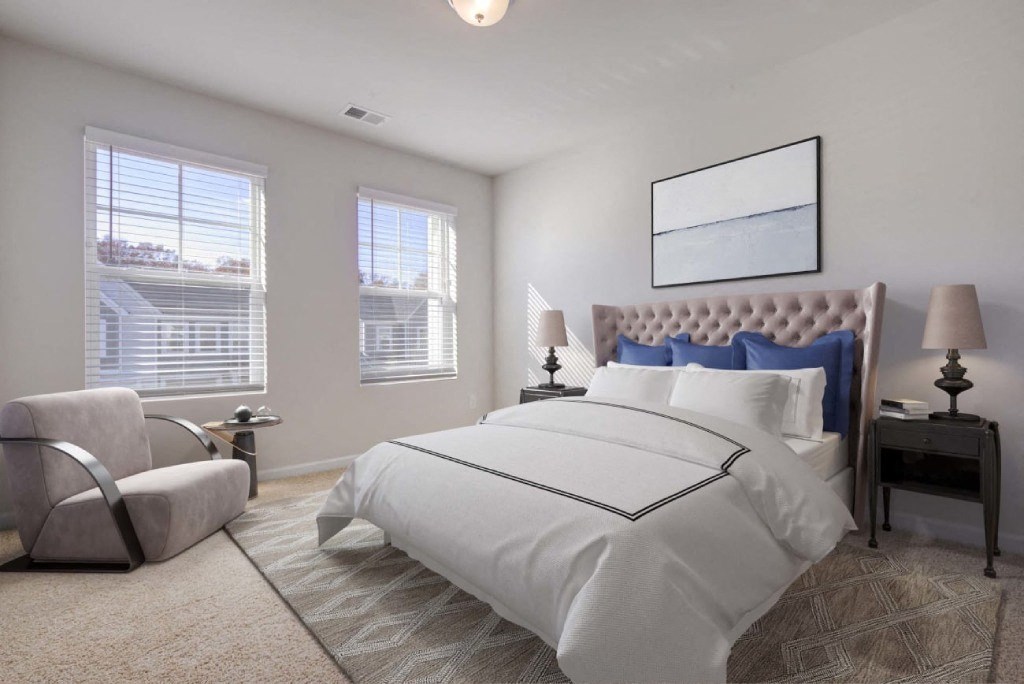 a bedroom with a bed and two windows