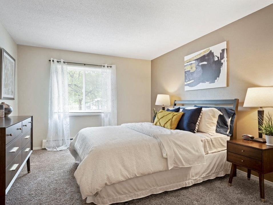 a bedroom with a bed and a dresser