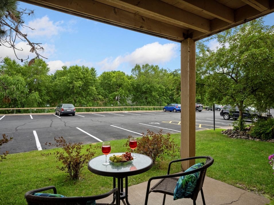 a patio with a table and chairs and a parking lot