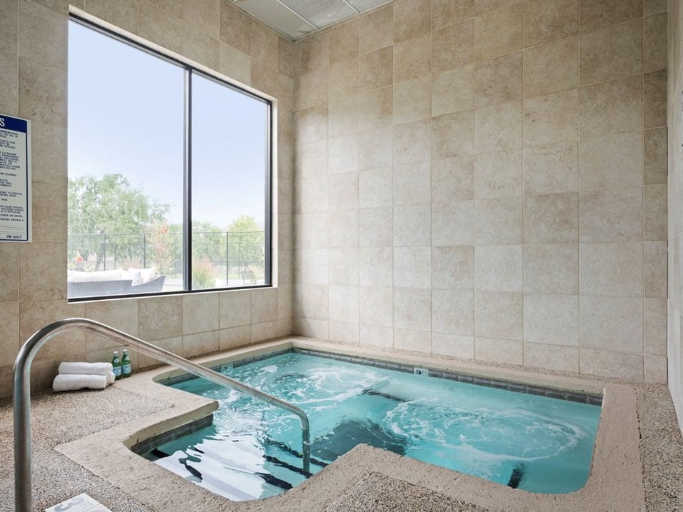 a jacuzzi tub with a window in a hotel bathroom