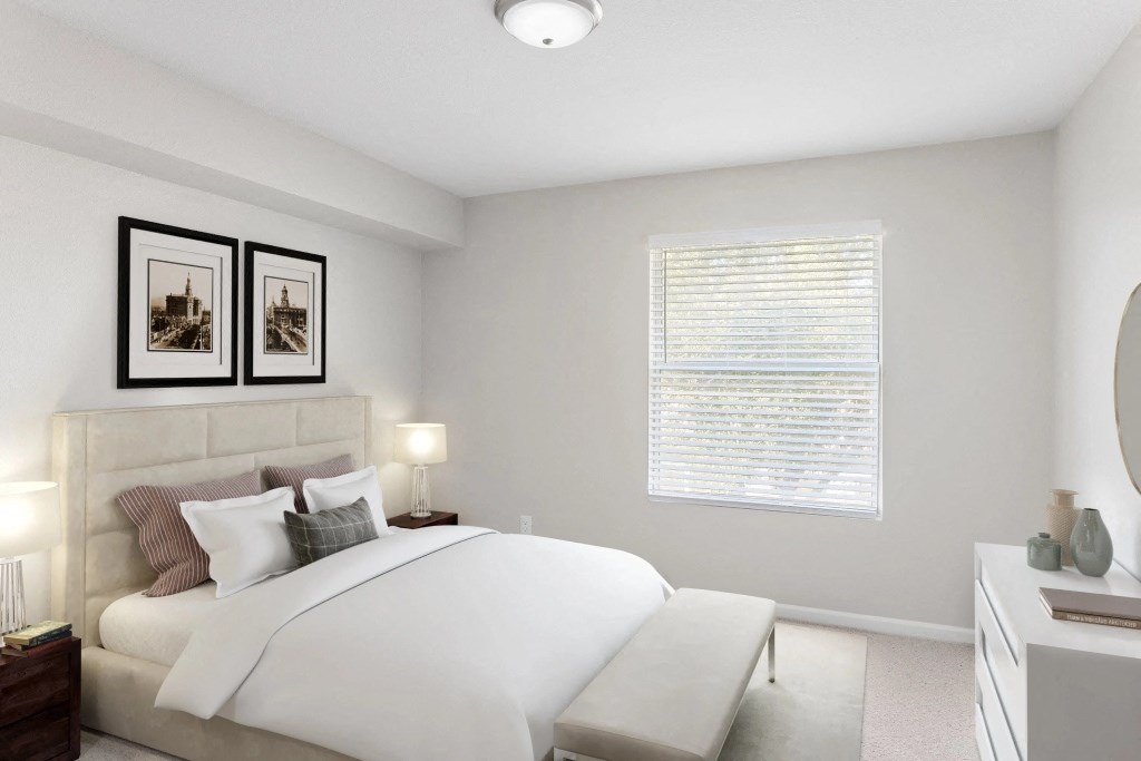 a white bedroom with a large bed and a window