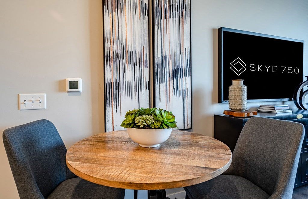 a dining room table with a plant on top of it