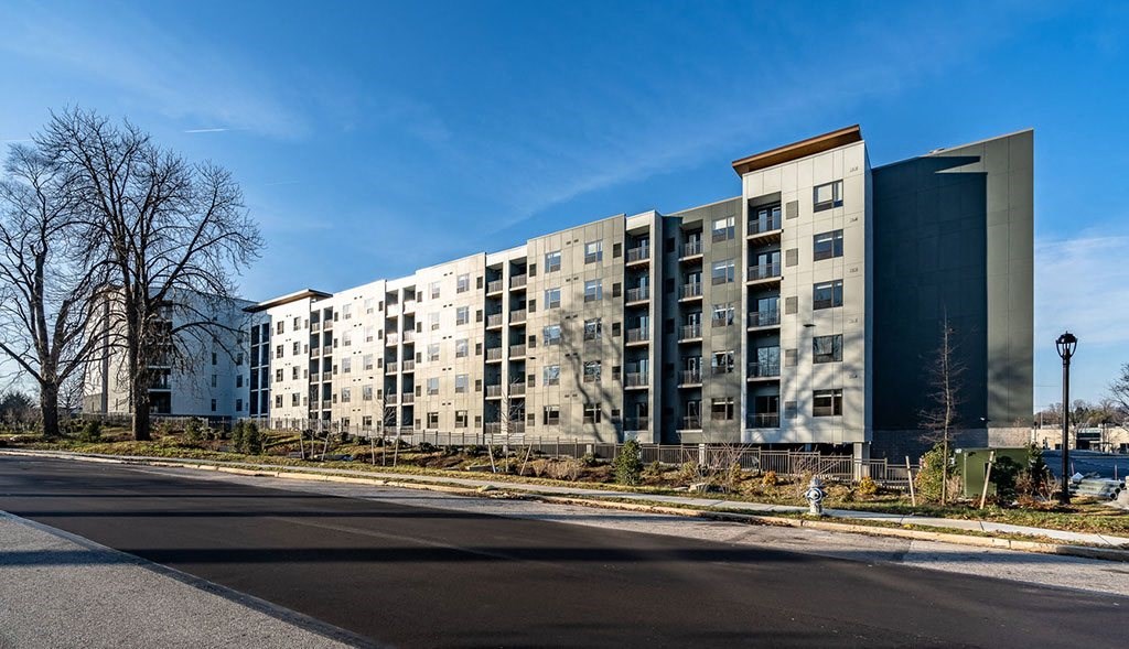 a large apartment building on the side of a street