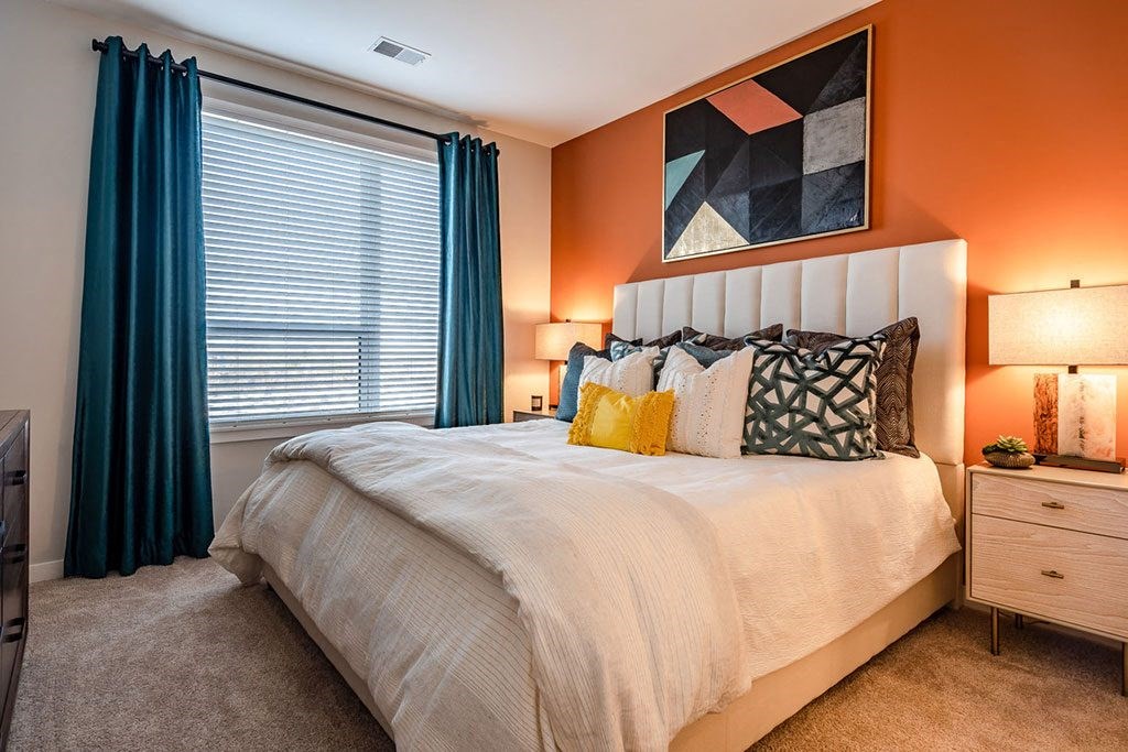 a bedroom with a large bed and a window