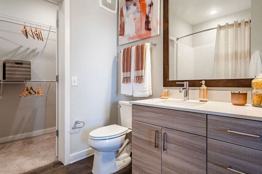 a bathroom with a toilet and a sink and a shower
