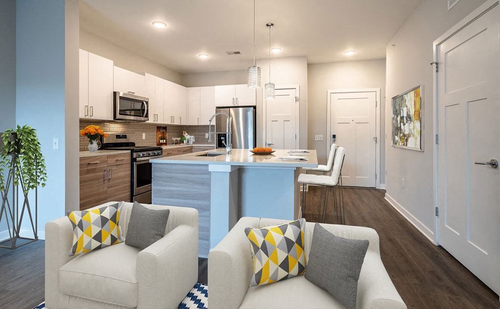 a living room and kitchen with a couch and a table