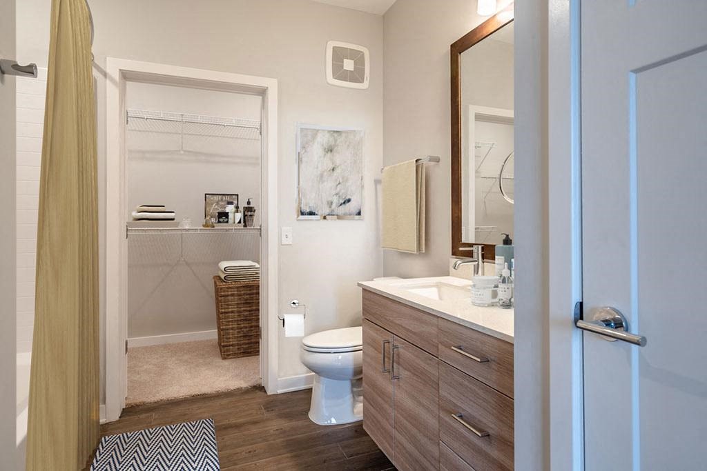 a bathroom with a white toilet and a geometric wall