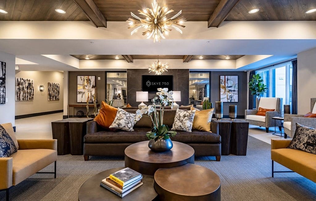 a living room with couches and chairs and a chandelier