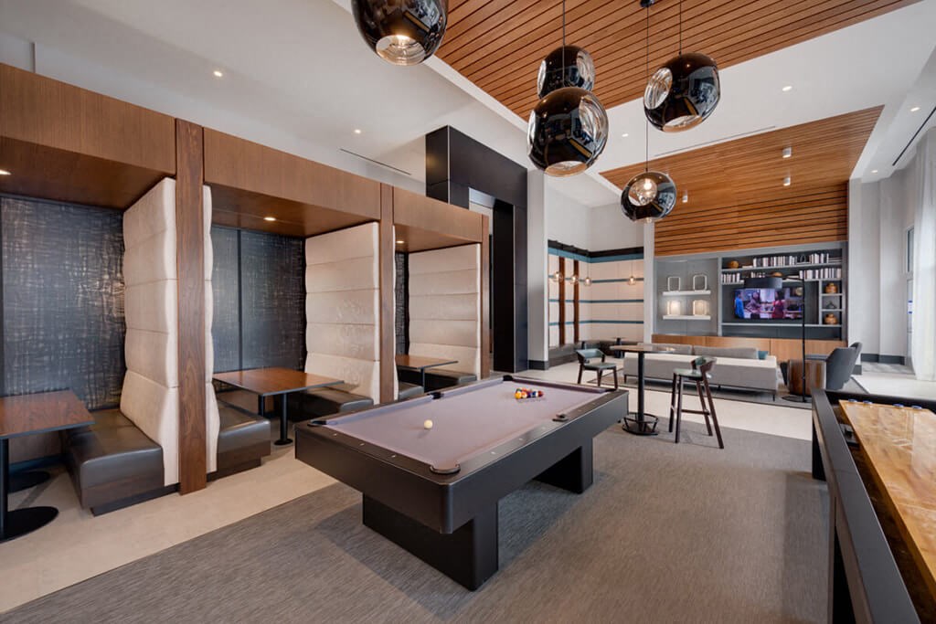 a game room with a pool table and a bar