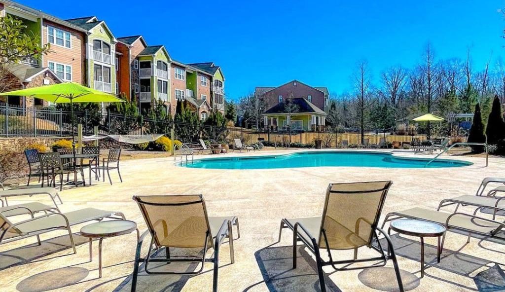 Pet-Friendly Apartments in Opelika, AL – The Crossings of Opelika - swimming pool and sundeck with chairs