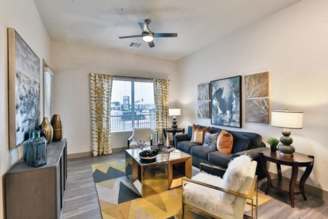 a living room with a couch and a ceiling fan