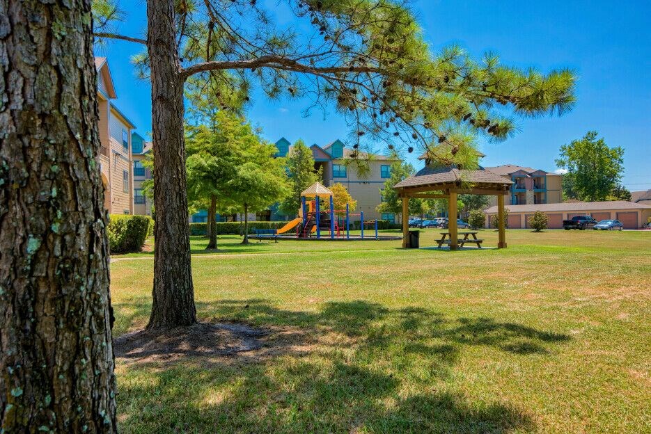 A playground at Lake Forest surrounded by grass
