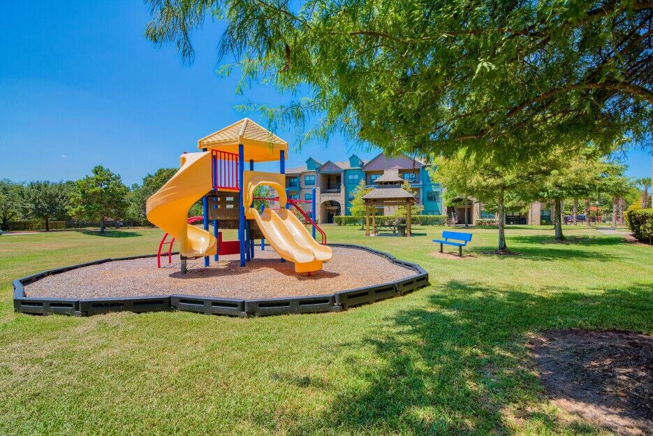 A playground at Lake Forest surrounded by grass