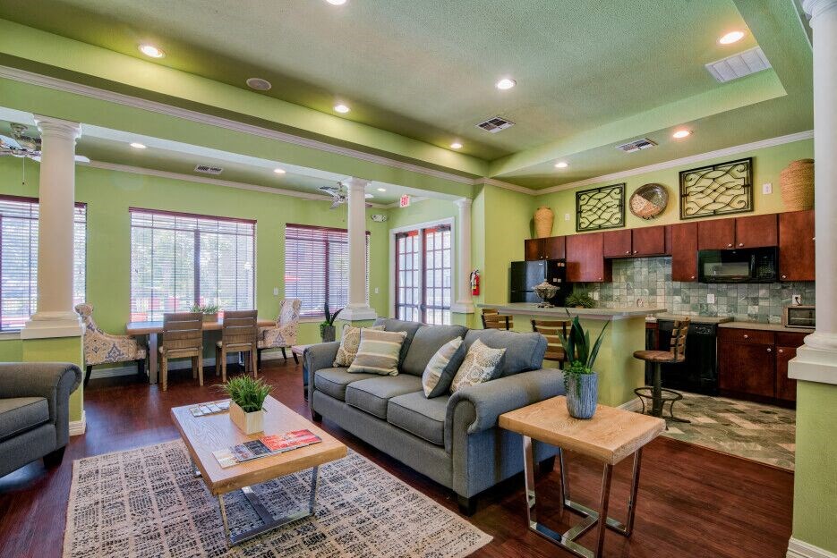 the clubhouse with a bar area and area to relax on a couch or chair