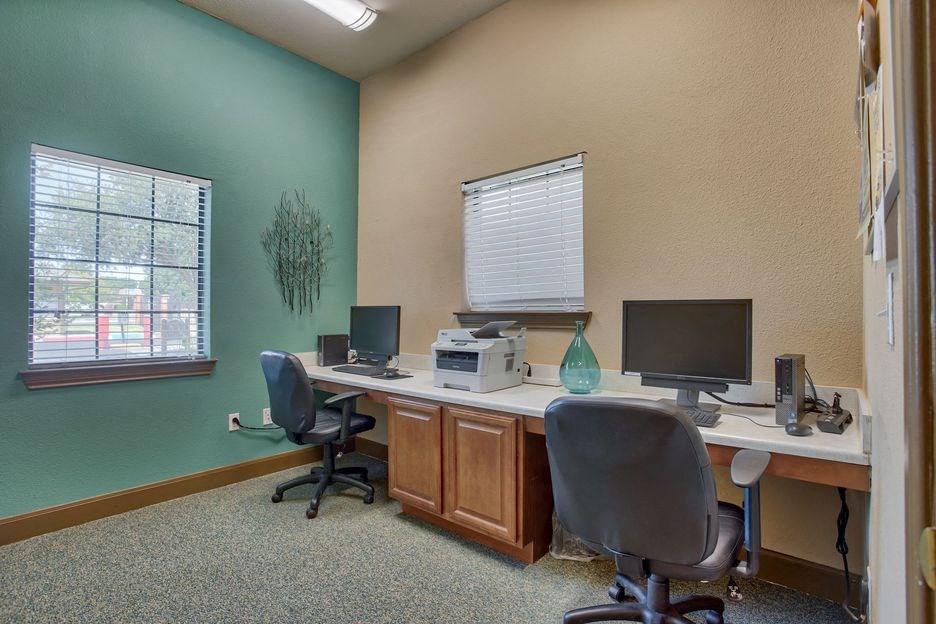 office room with desk and chair and computers