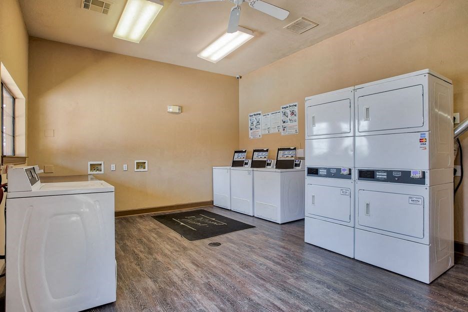laundry room with wood floor and washer and dryer