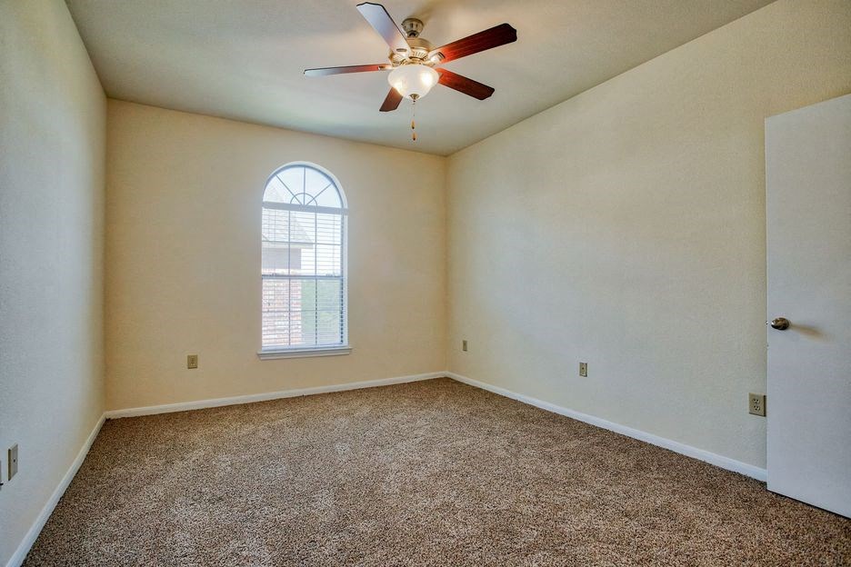 bedroom with carpet floor and window and ceiling fan/light